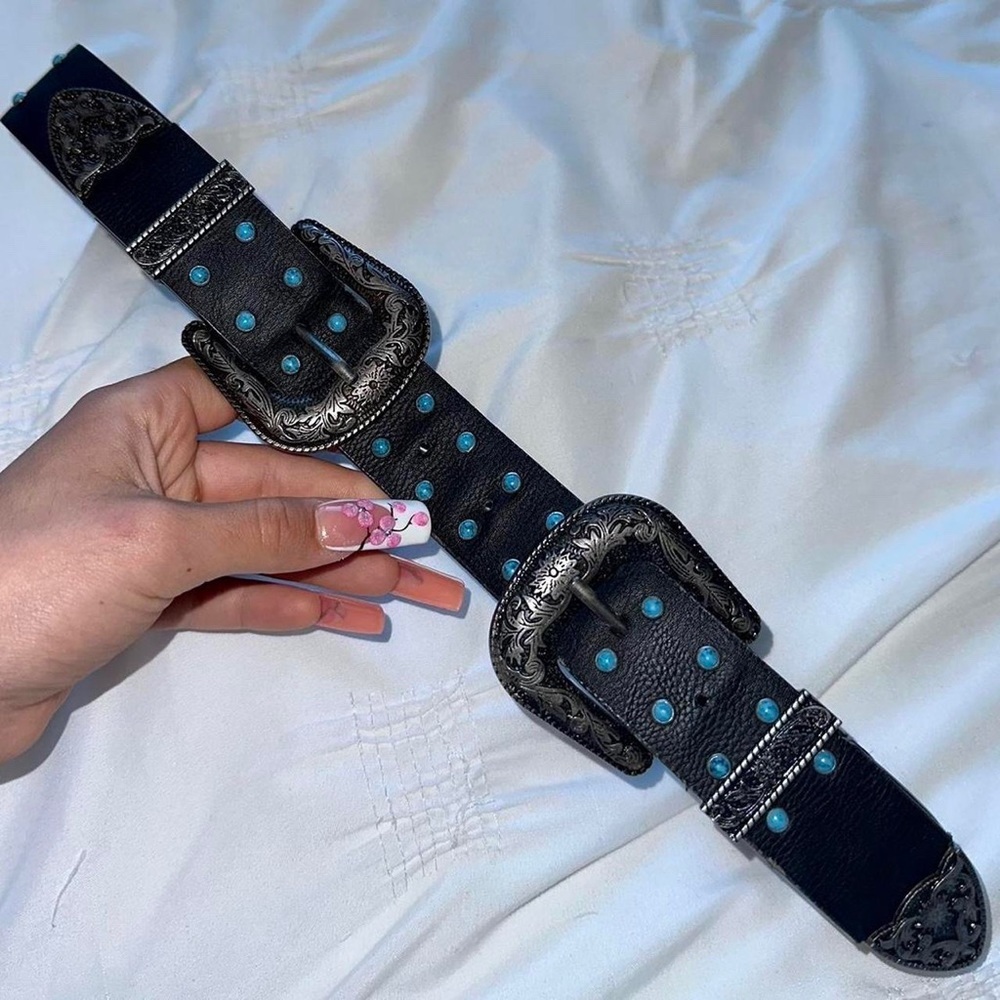 Black leather double buckle belt with detailed metal hardware and blue beads